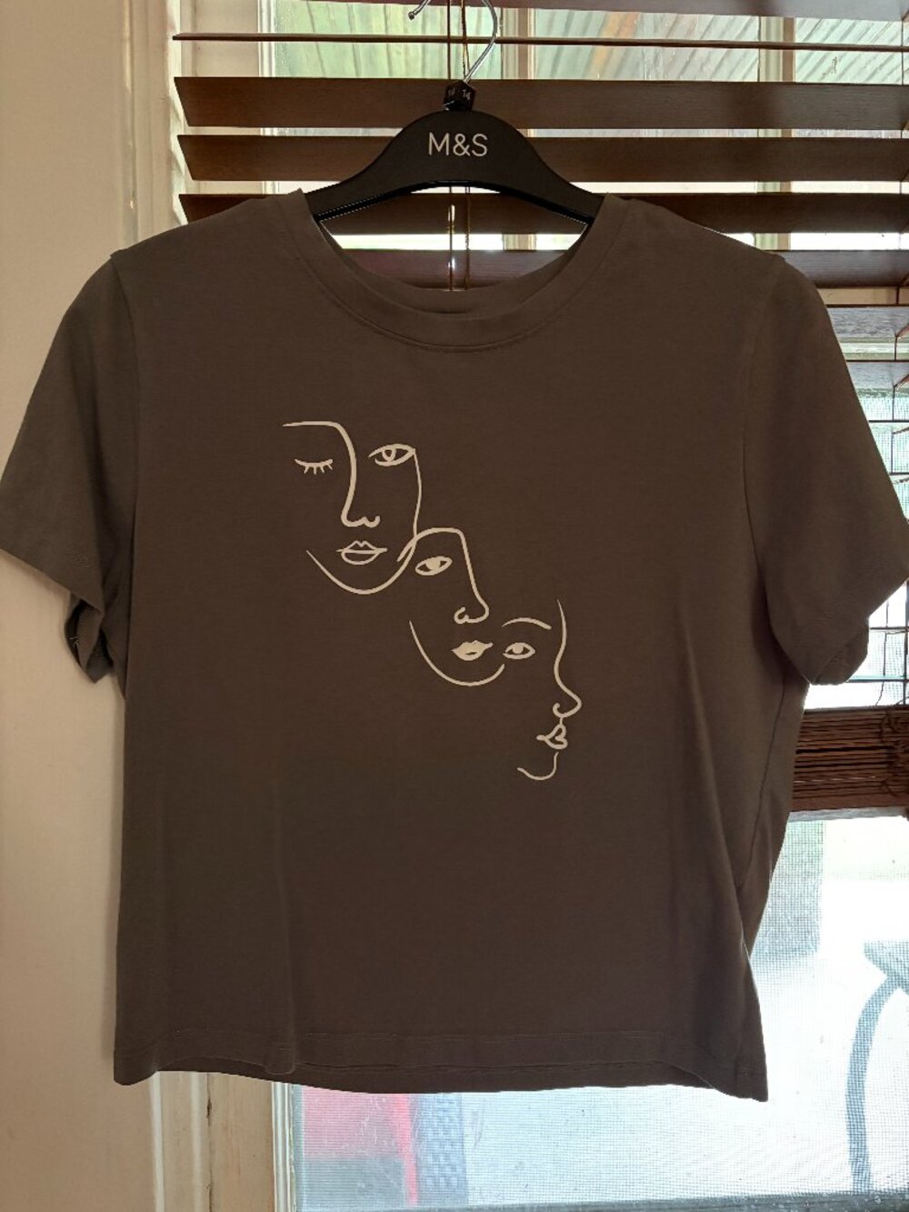 Grey tshirt with white women's outline faces